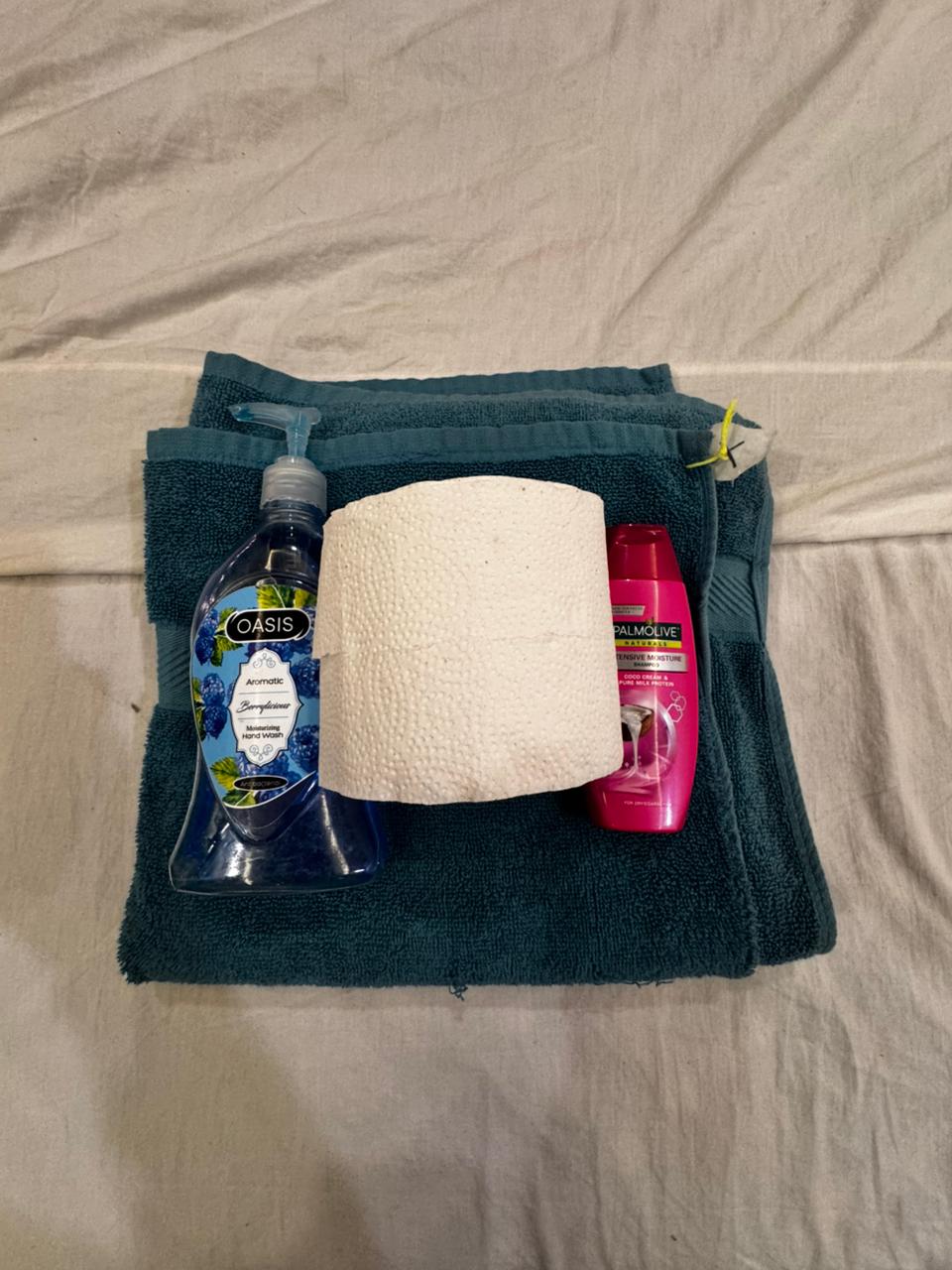 Folded towels, hand wash and toiletries provided for guests at the Aangan three-bedroom apartment in E-11, Islamabad