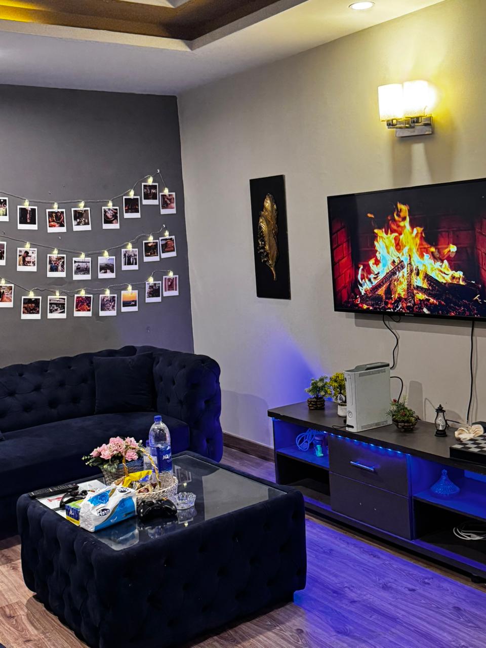 Wall-mounted TV and media console with a games console in the living room of the Aangan three-bedroom apartment in E-11, Islamabad