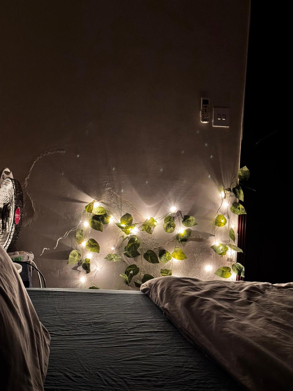 String lighting above the beds in a twin bedroom of the Aangan three-bedroom apartment in E-11, Islamabad