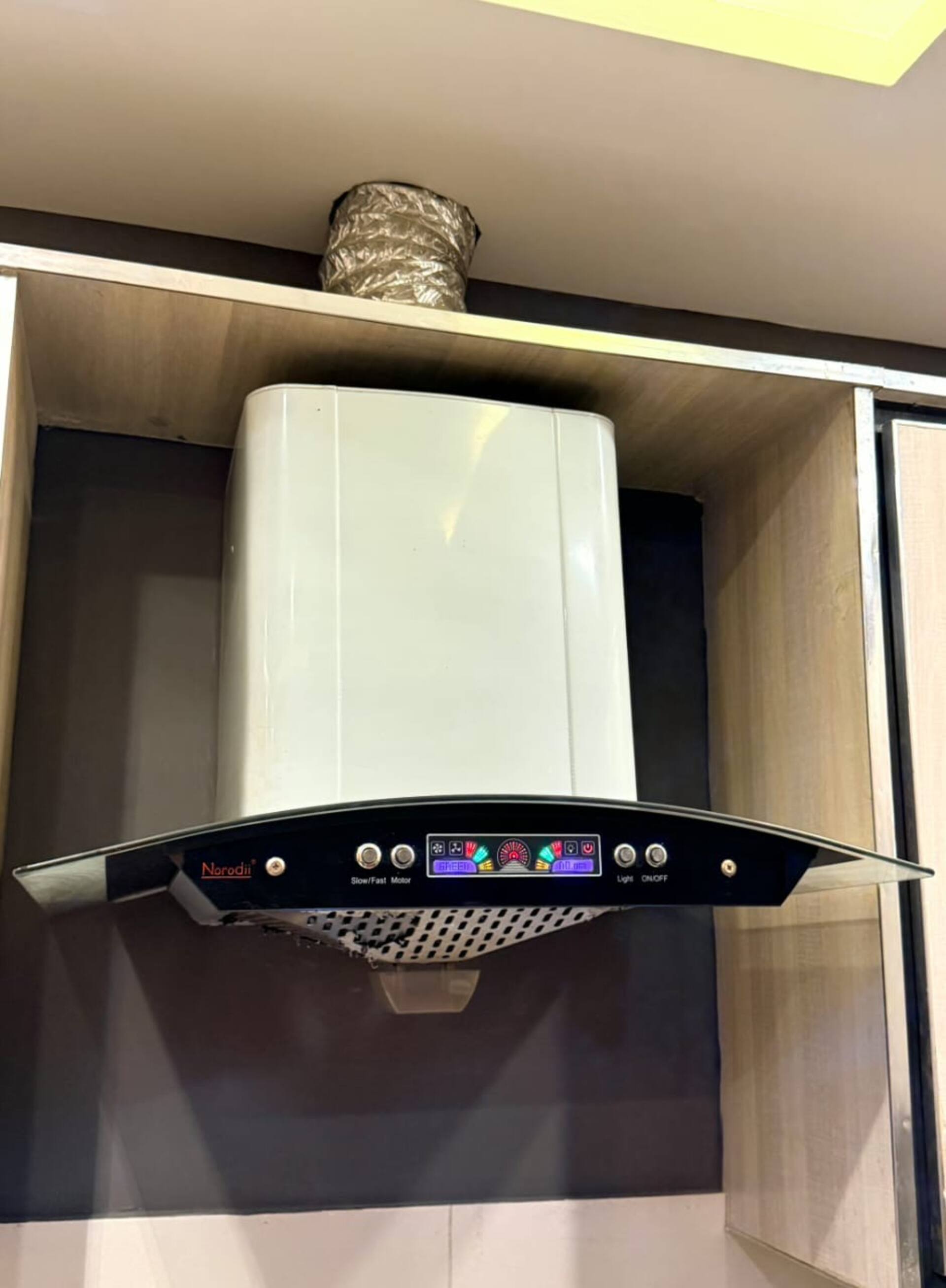 Extractor hood above the kitchenette of The Amber Haven, the Aangan one-bedroom apartment facing Grand Jamia Mosque in Bahria Town Lahore