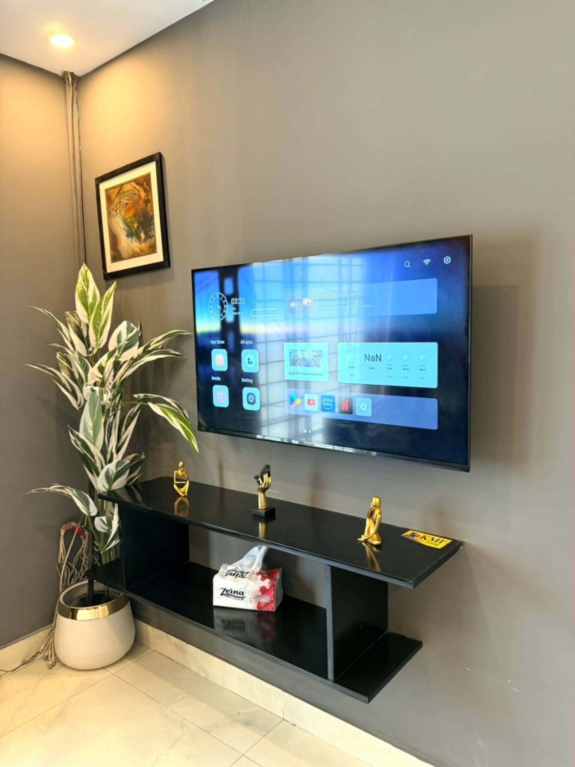 Large smart TV with streaming apps in The Amber Haven, the Aangan one-bedroom apartment facing Grand Jamia Mosque in Bahria Town Lahore