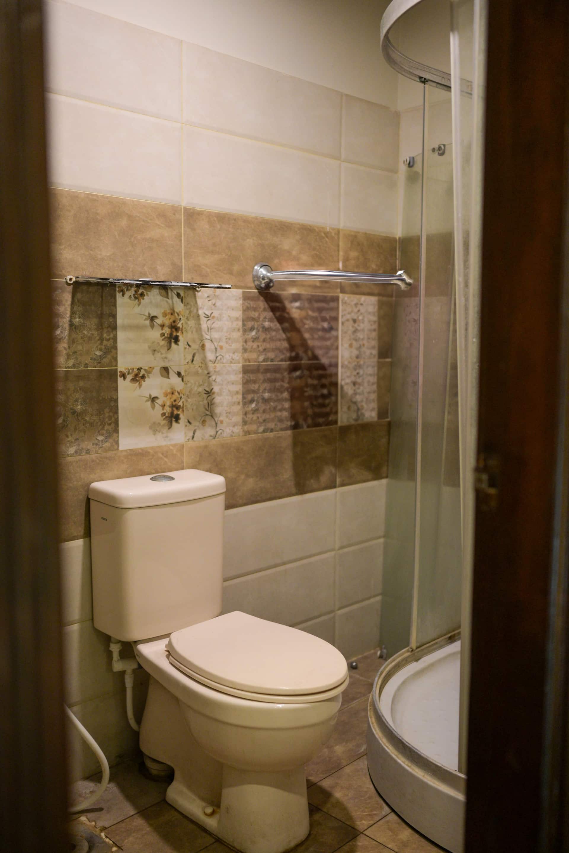 Bathroom with a WC and glass shower enclosure in the Aangan three-bedroom gaming suite in Apollo Tower, E-11 Islamabad