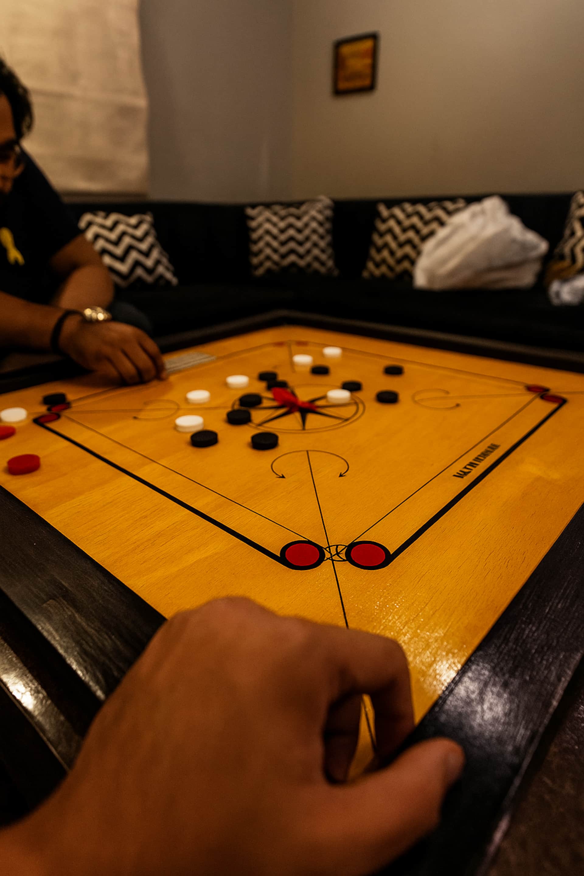 Guests playing carrom in the lounge of the Aangan three-bedroom gaming suite in Apollo Tower, E-11 Islamabad