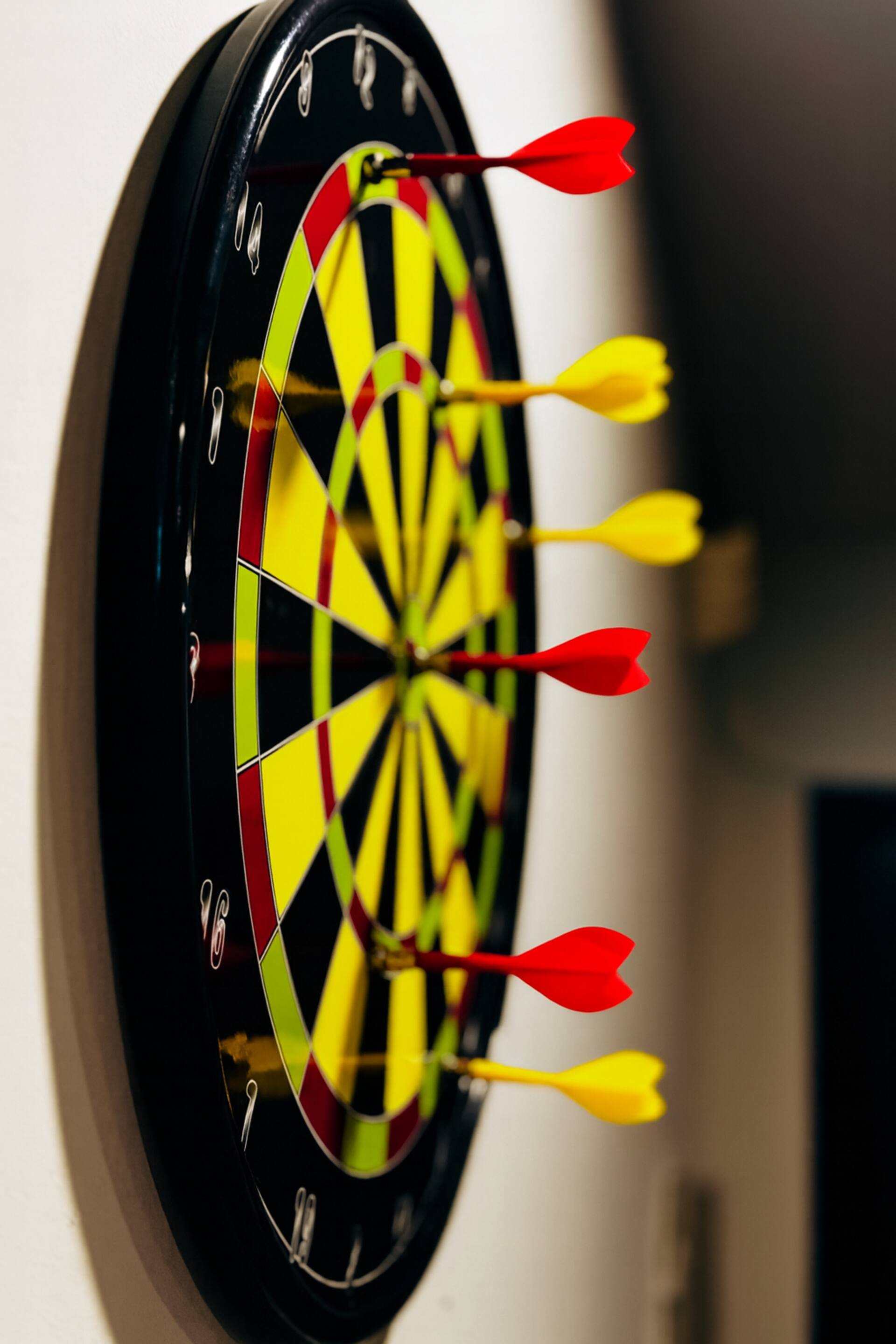 Dartboard with darts on the wall of the Aangan three-bedroom gaming suite in Apollo Tower, E-11 Islamabad