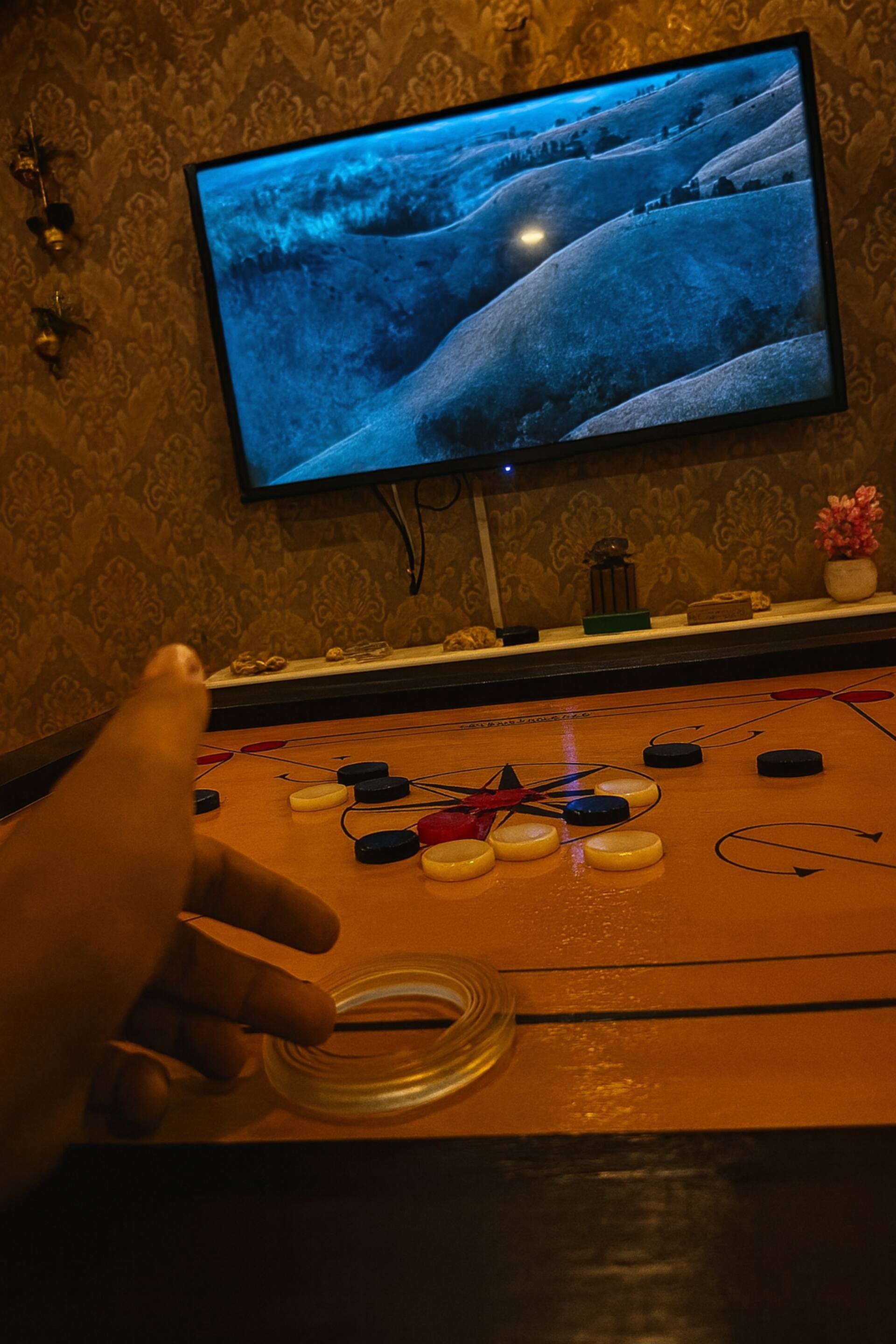 Dot-on-board game being played below the TV in the Aangan three-bedroom gaming suite in Apollo Tower, E-11 Islamabad