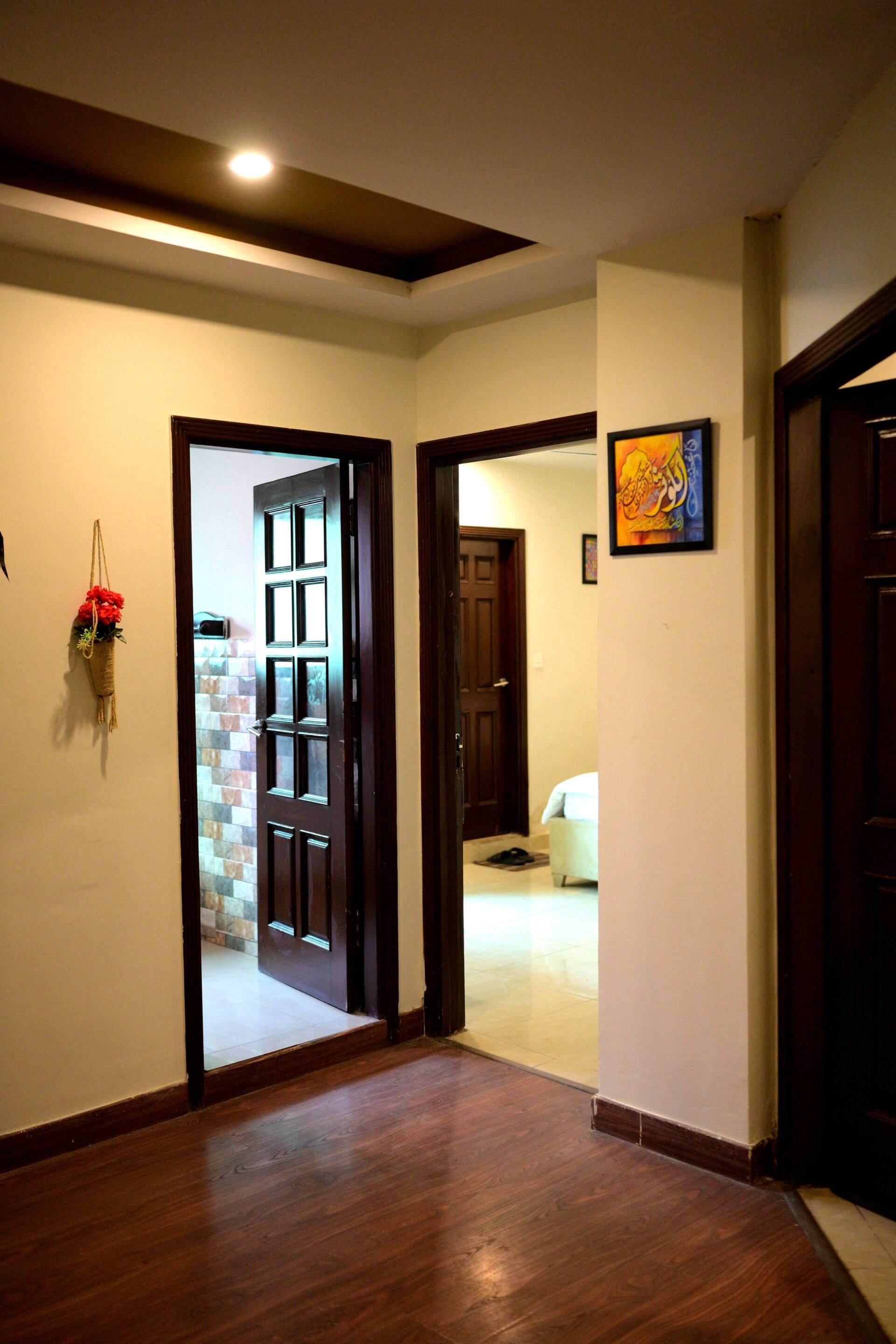 Internal hallway connecting the bedrooms of the Aangan three-bedroom gaming suite in Apollo Tower, E-11 Islamabad