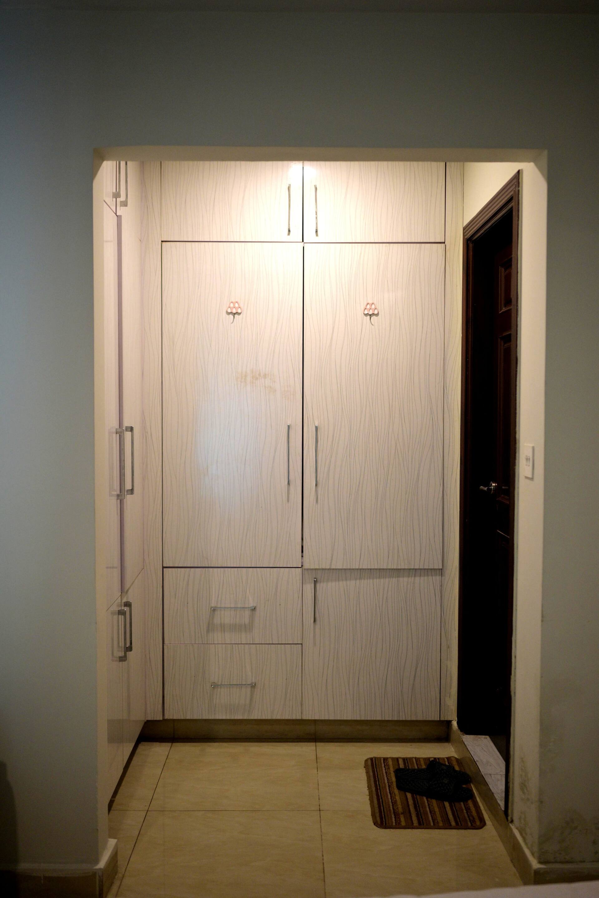 Built-in wardrobe providing clothing storage in the Aangan three-bedroom gaming suite in Apollo Tower, E-11 Islamabad
