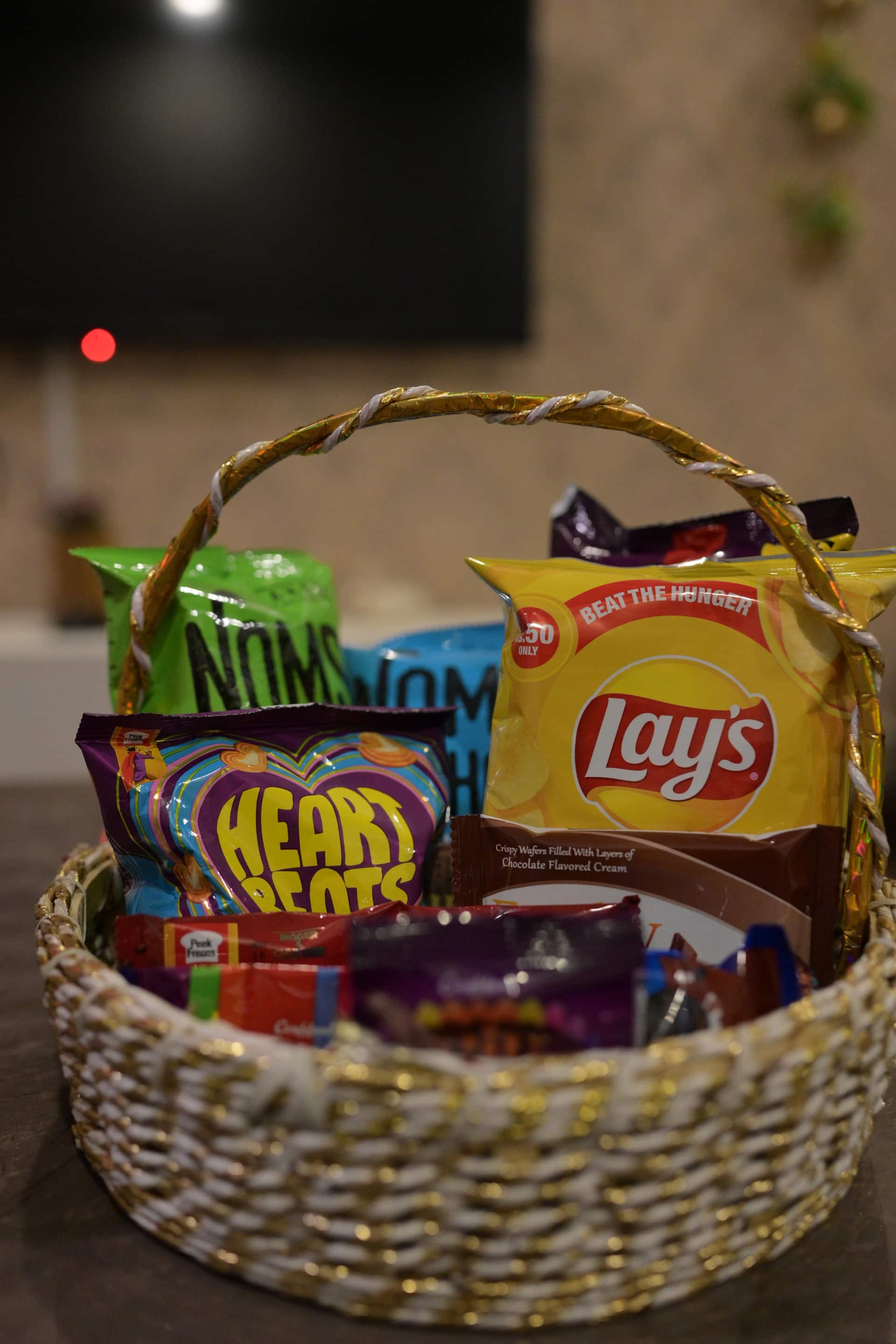 Basket of complimentary welcome snacks at the Aangan three-bedroom gaming suite in Apollo Tower, E-11 Islamabad