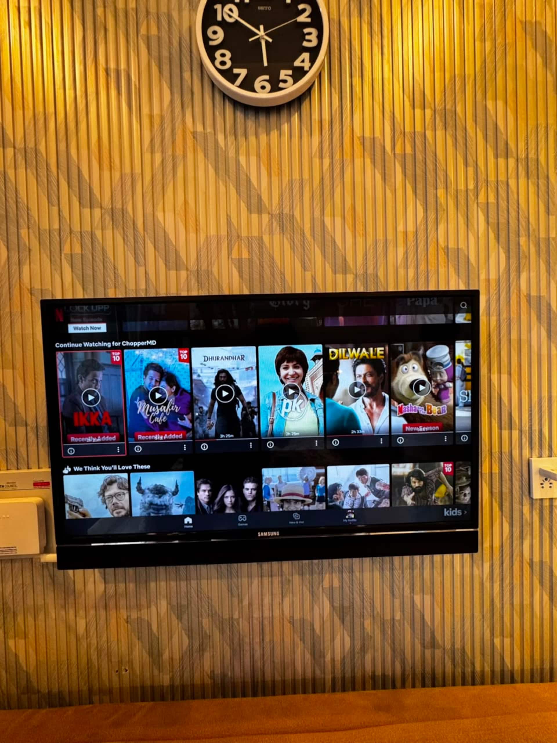 Wall-mounted smart TV showing streaming apps in the Aangan studio apartment near Islamabad International Airport