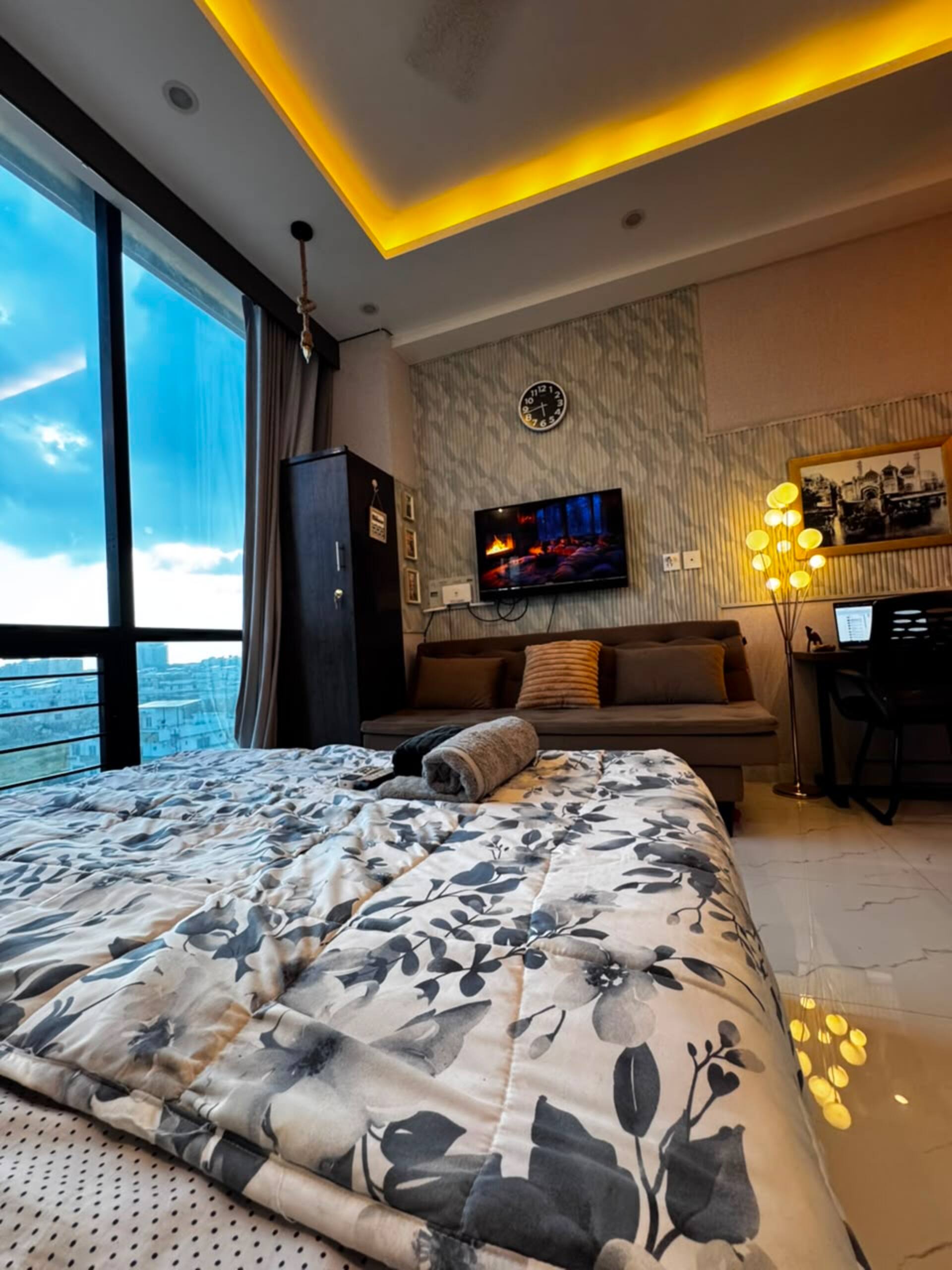 Evening view of the studio with warm cove lighting in the Aangan studio apartment near Islamabad International Airport