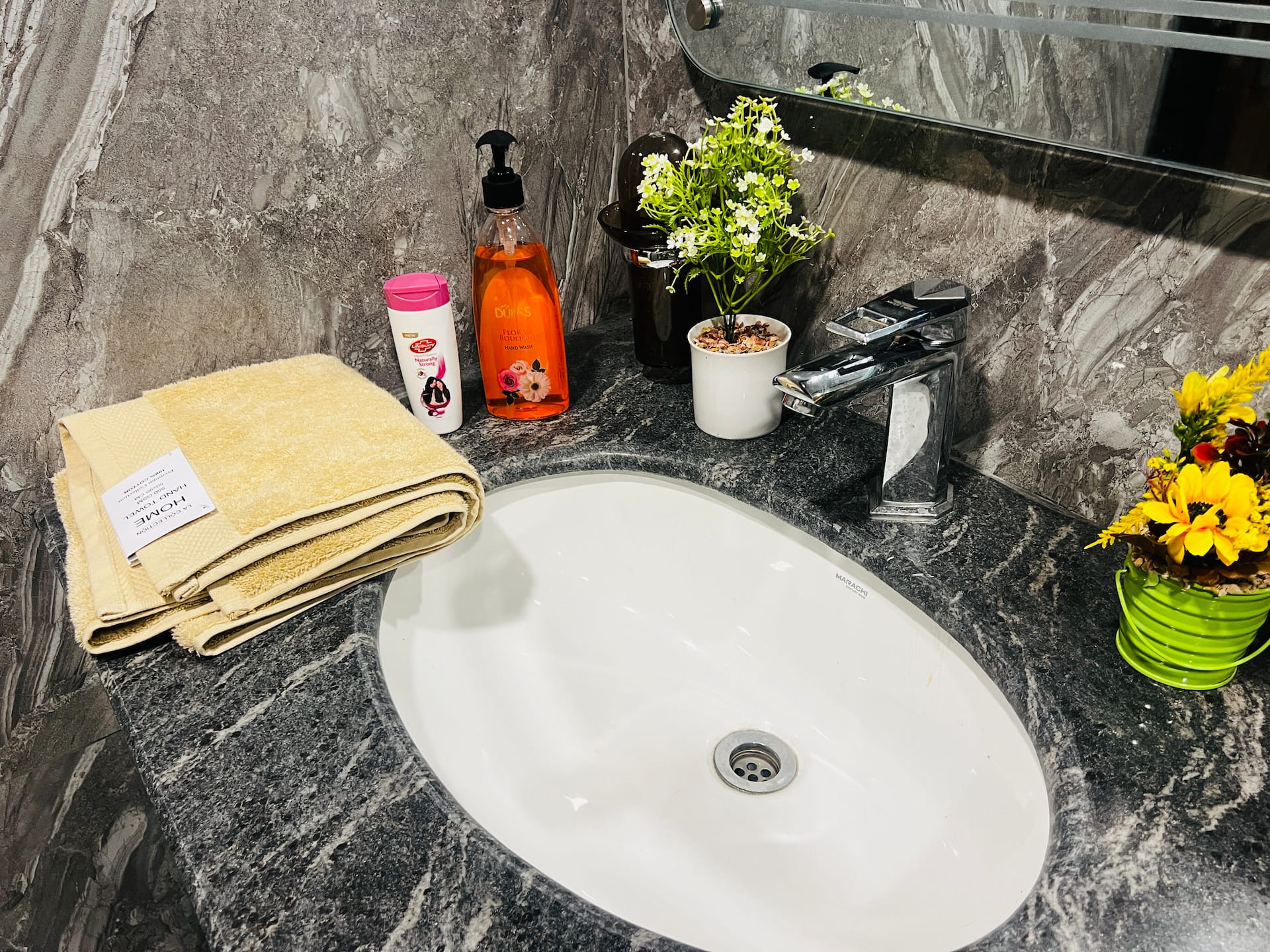 Bathroom vanity with fresh towels and toiletries in the 3-bedroom Aangan apartment in Zeta Mall, Islamabad