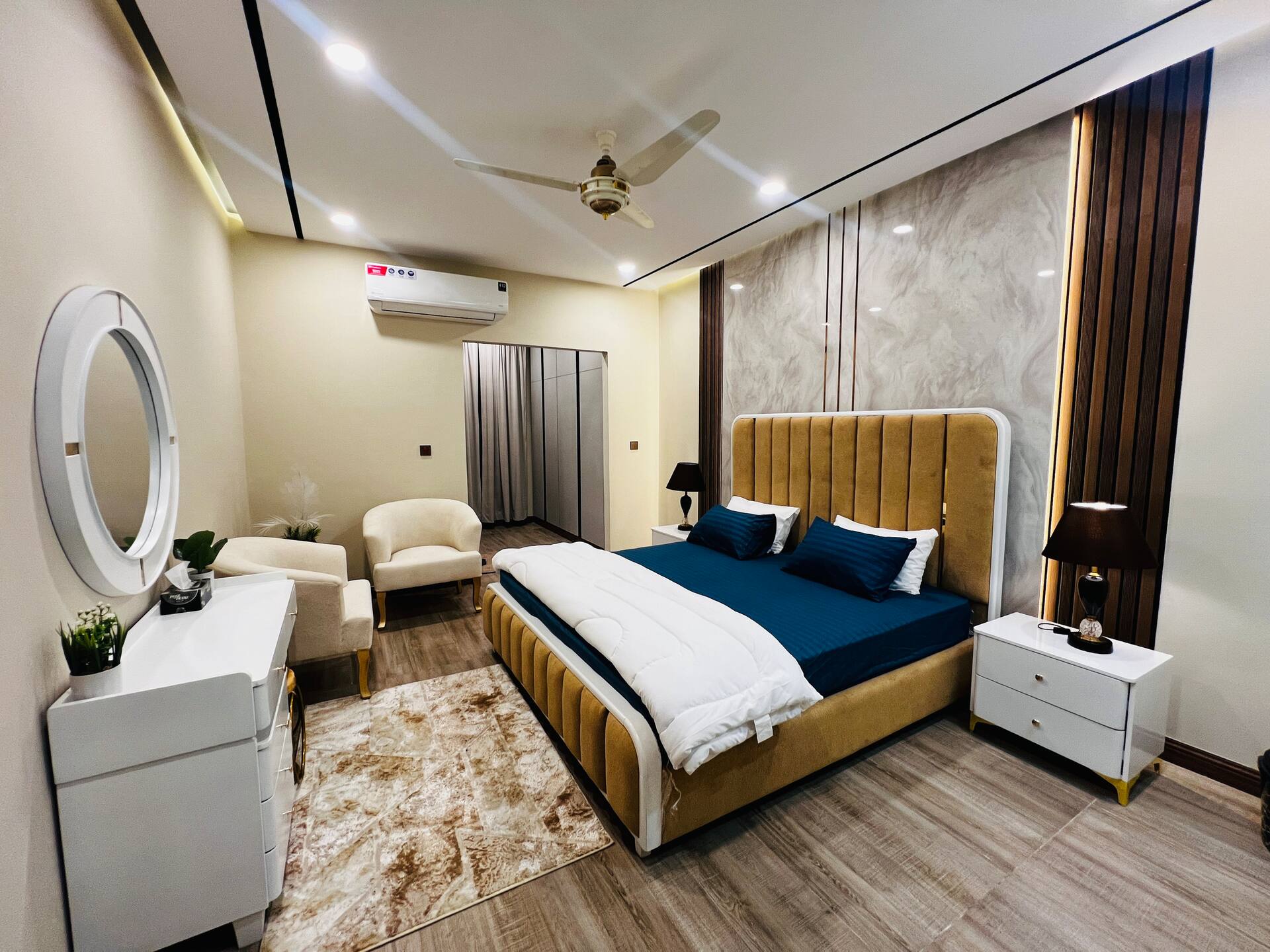 Bedroom with a dressing table and mirror in the 3-bedroom Aangan apartment in Zeta Mall, Islamabad