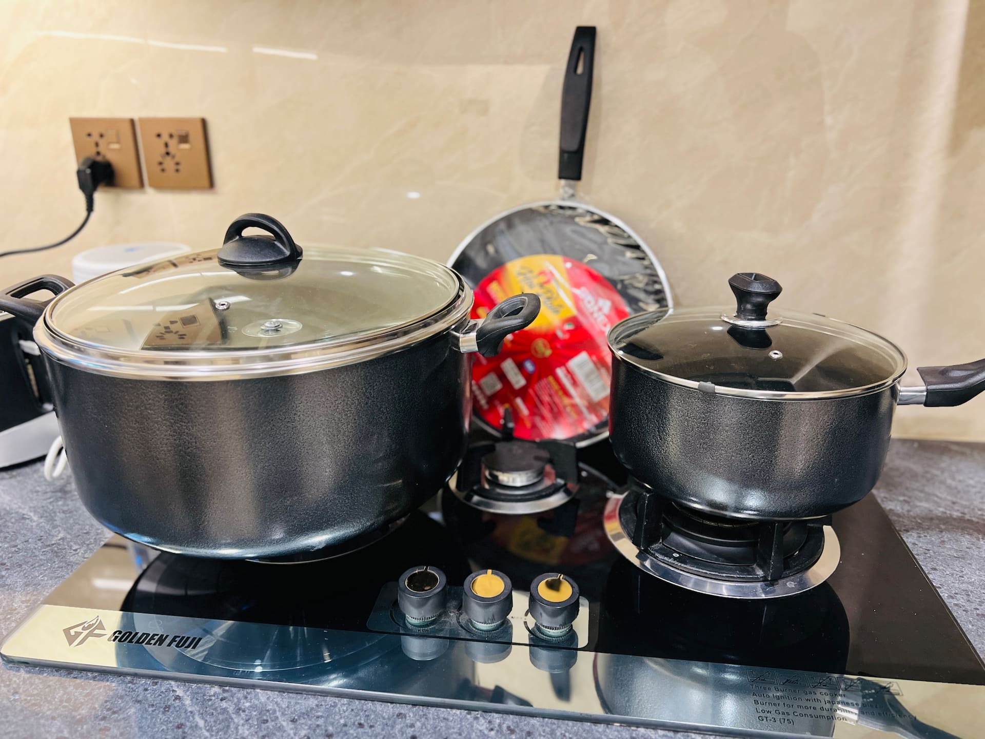 Cooking range with pots and pans in the kitchen of the 3-bedroom Aangan apartment in Zeta Mall, Islamabad