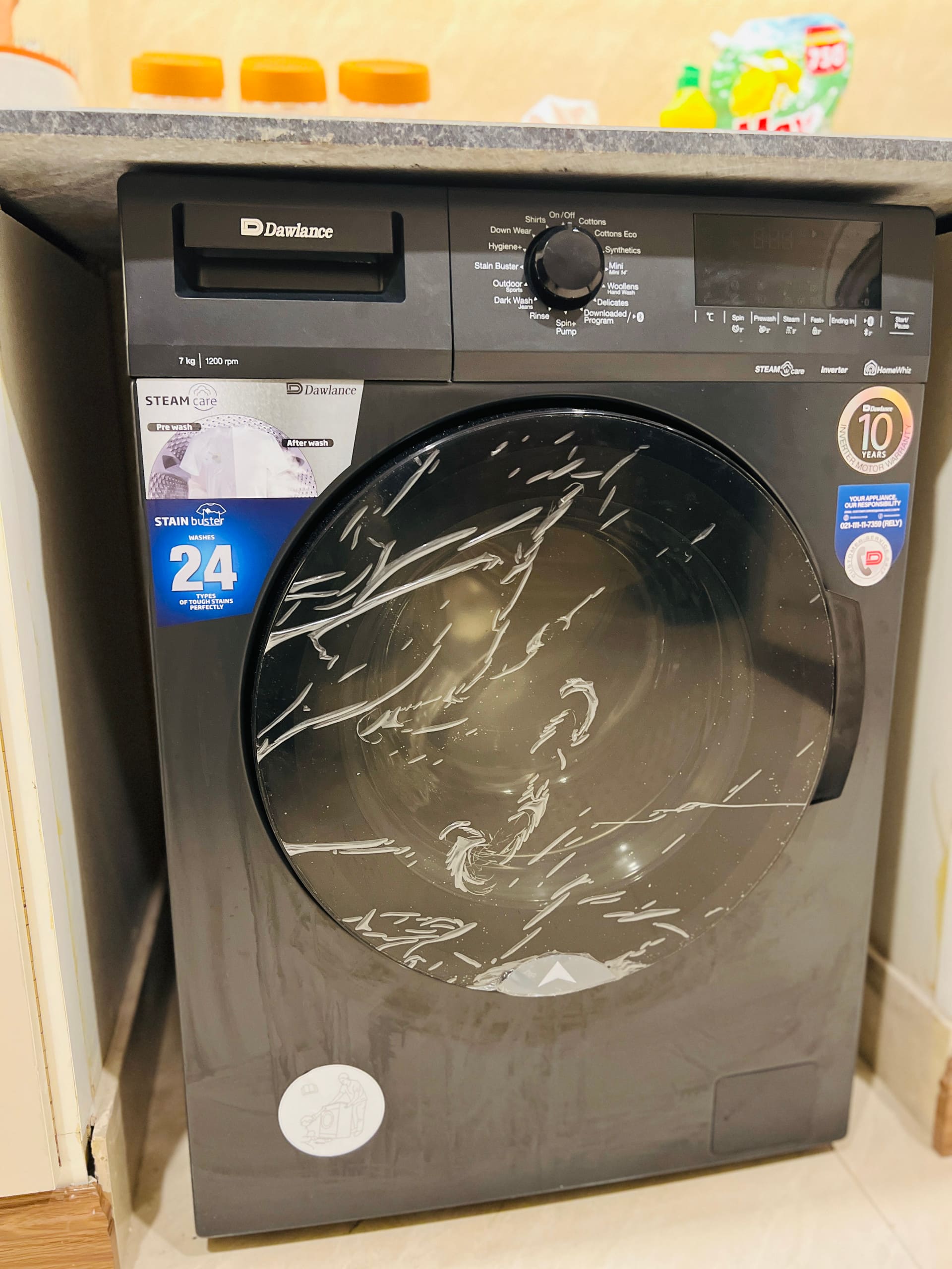 Automatic washing machine in the laundry area of the 3-bedroom Aangan apartment in Zeta Mall, Islamabad